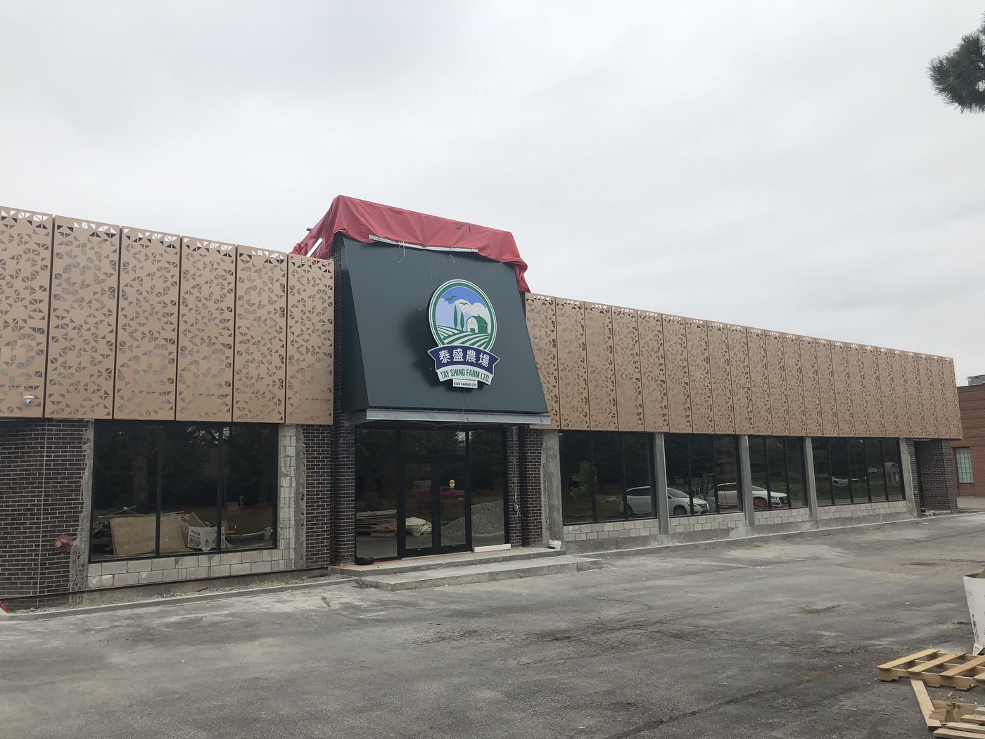 Completed single-storey retail building with a masonry and glazed storefront.